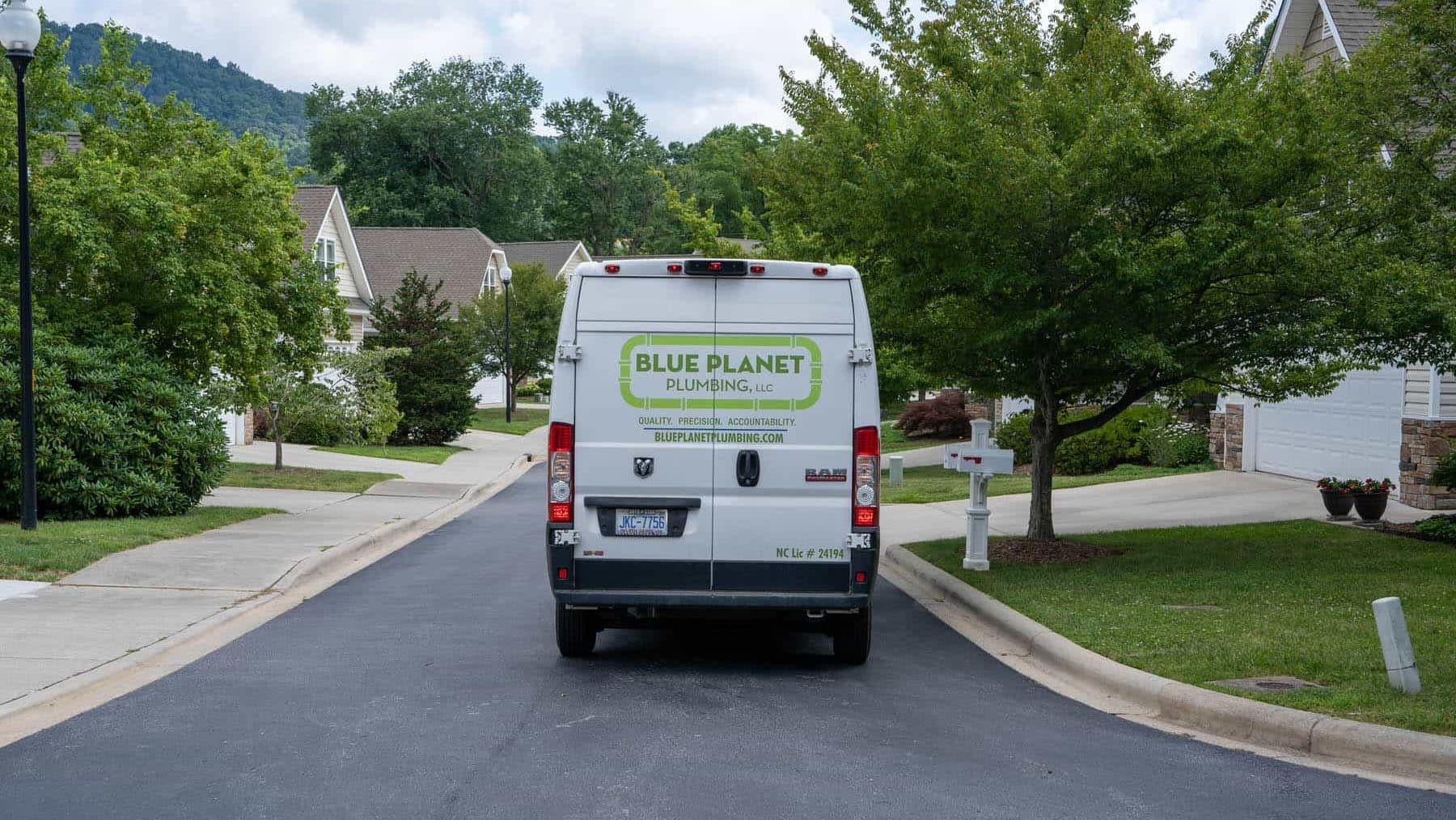 Blue Planet Plumbing van driving through neighborhood
