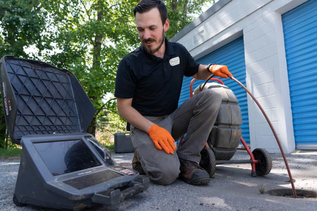 technician using drain camera to inspect clog