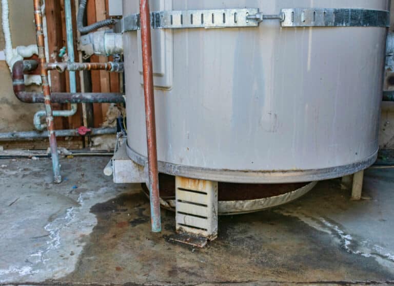 Water heater leaking water across floor.